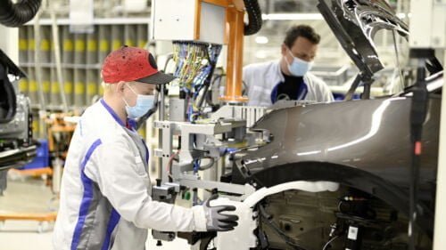 Two employees at Volkswagen in Zwickau install the front end on the ID.3. For the restart of production, a catalogue of measures for health protection was agreed between the company and the works council, which provides for the wearing of mouth-nose protection at workplaces with a distance of less than 1. 5 metres from each other.