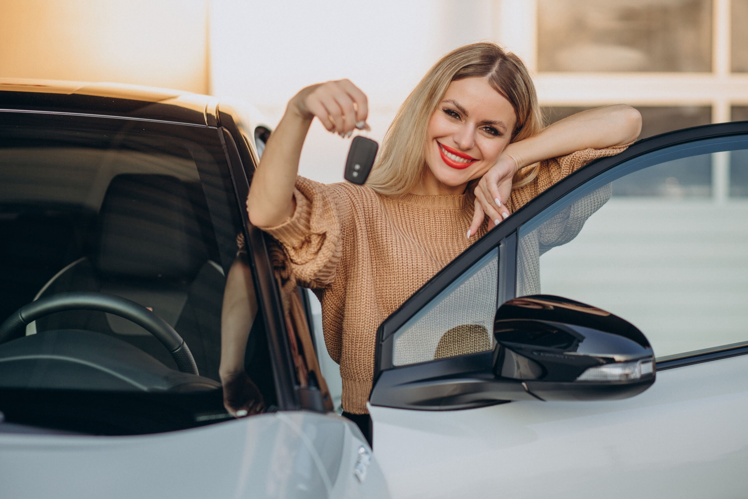 Woman holding keys from her new car